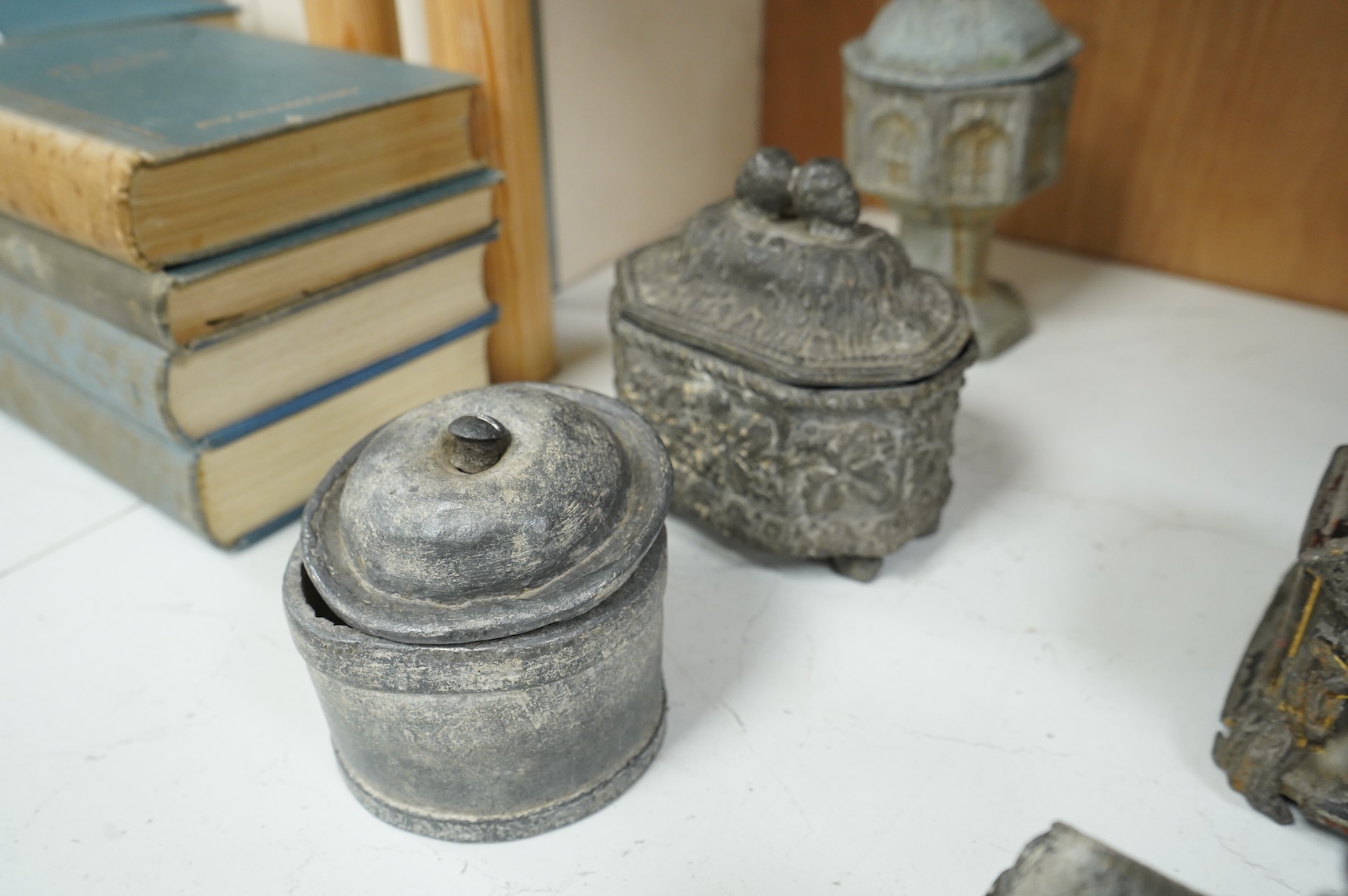 A collection of ten early 19th century lead tobacco boxes, one in the form of a goat’s head, tallest 20cm